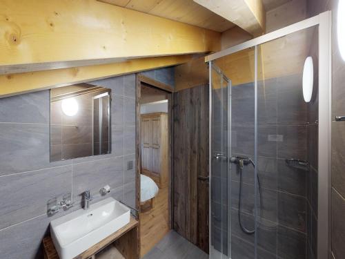 a bathroom with a sink and a shower at Duplex apartment in Veysonnaz in Veysonnaz