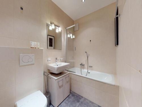 a bathroom with a sink and a toilet and a tub at Apartment in Veysonnaz with Ski-In Ski-Out in Veysonnaz