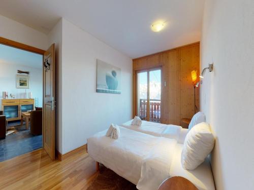 a bedroom with a bed and a living room at Apartment in Veysonnaz with Ski-In Ski-Out in Veysonnaz
