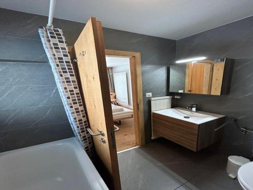 a bathroom with a tub and a sink and a toilet at Apartment in Swiss Alps near Cable Car in Veysonnaz