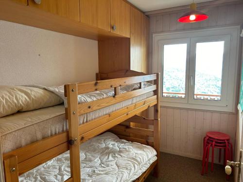 a bedroom with two bunk beds and a window at Apartment in Veysonnaz with balcony in Veysonnaz