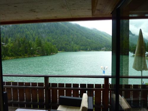 a view of a lake from a window at Hotel Mont.Lac in Champex