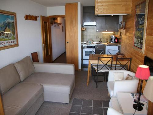 a living room with a couch and a table at Studio in Veysonnaz near Ski Lift in Veysonnaz
