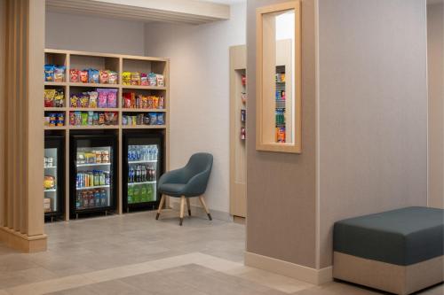 a waiting room with a chair and some drinks at TownePlace Suites by Marriott Eugene in Eugene