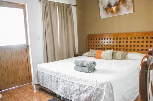una camera da letto con un letto con asciugamani sopra di La Ventana del Tepozteco a Tepoztlán