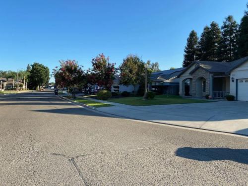 an empty street in a residential neighborhood with houses at Suite Spot-an extended stay casita with charm #2 in Visalia