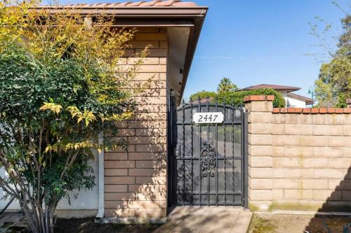 a gate to a house with the number on it at Suite Spot-an extended stay casita with charm #2 in Visalia