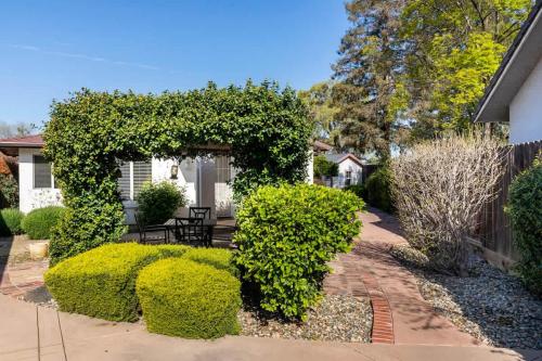 a garden with a bench and some bushes at Suite Spot-an extended stay casita with charm #2 in Visalia
