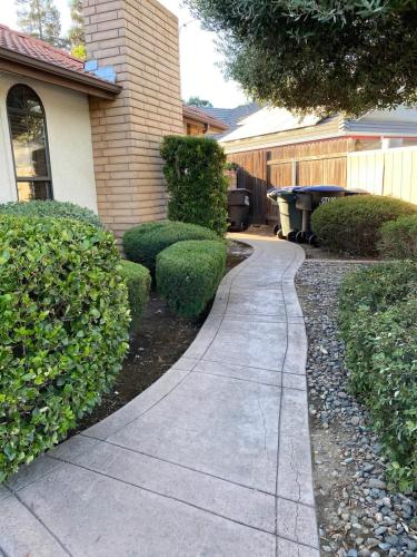 a concrete walkway in front of a house at Suite Spot-an extended stay casita with charm #2 in Visalia