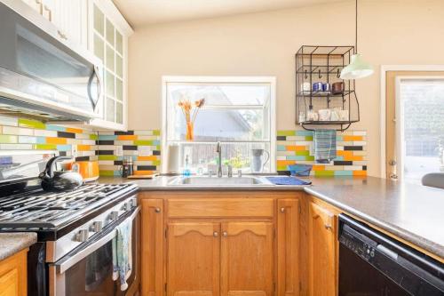 a kitchen with a sink and a stove at Suite Spot-an extended stay casita with charm #2 in Visalia