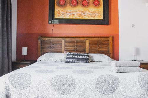 a large bed with two pillows on top of it at La Ventana del Tepozteco in Tepoztlán