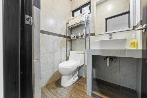 a bathroom with a toilet and a sink at Hotel Boutique Árbol de la Vida in Taxco de Alarcón