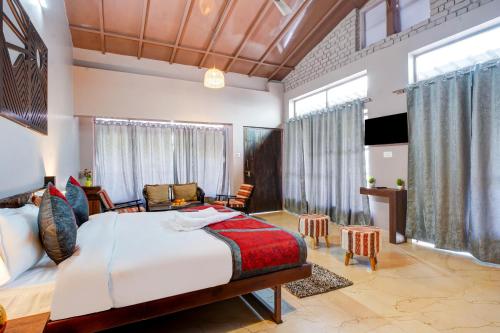 a bedroom with a bed and a living room at Natures Vibe Stays - 4 BHK Fruit Orchard Villa in Mukteswar