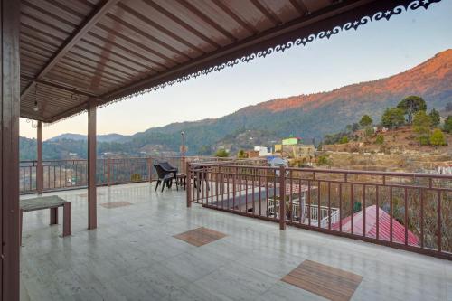 a balcony with a view of a mountain at Natures Vibe Stays - 4 BHK Fruit Orchard Villa in Mukteswar