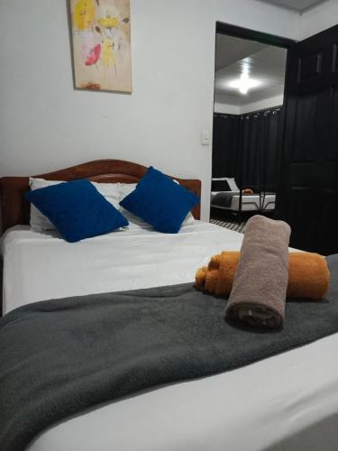 a bed with a stuffed animal on top of it at Hotel Boutique D Angelo in Manzanillo
