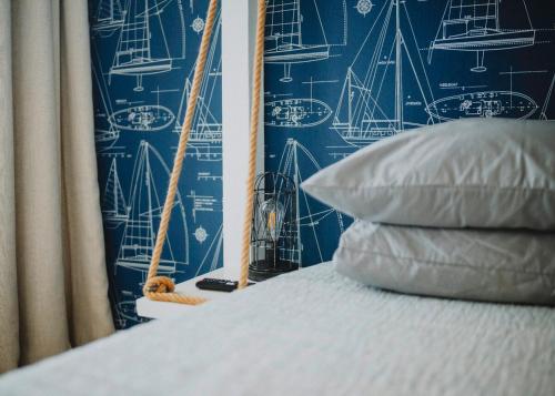 a bed with a pillow next to a wall with a sail at Retreat on Lake Athens in Athens