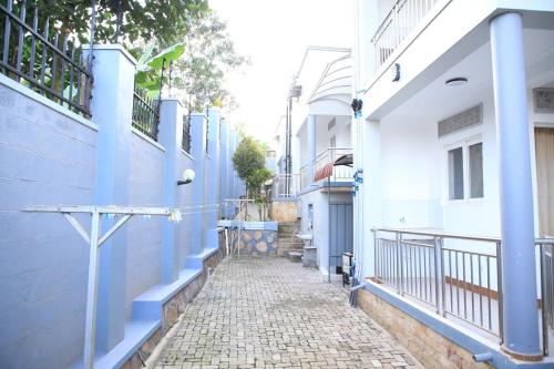 an alley with blue and white buildings and a street at Buwate Hill view Luxury Suites in Kampala