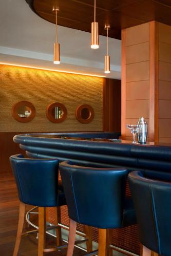 a bar with blue chairs in a restaurant at Sheraton Sopot Hotel in Sopot
