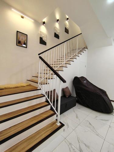 a staircase in a house with a suitcase on the floor at D Banyan Homestay, Bukit Banyan in Sungai Petani