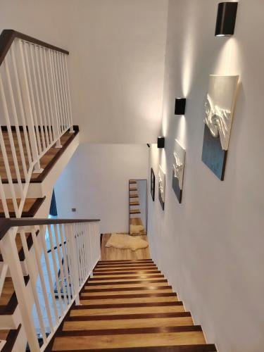 a staircase in a house with white walls and wooden floors at D Banyan Homestay, Bukit Banyan in Sungai Petani