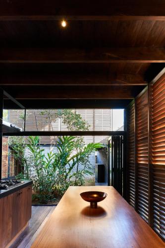 a wooden table in a kitchen with a large window at Ganga-Langa in Panadura