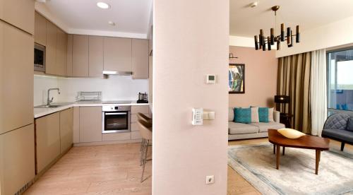a kitchen and living room with a couch and a table at Somerset Maslak Istanbul in Istanbul