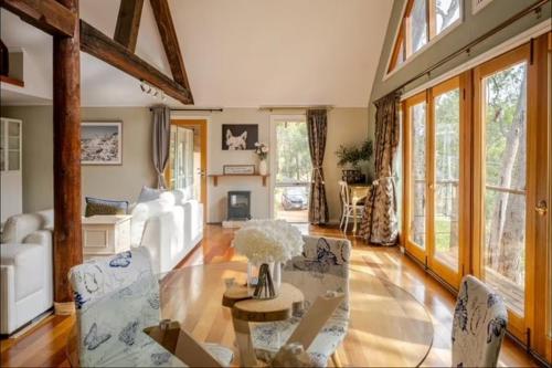 a living room with a glass table and chairs at Bickley Tree Stay in Bickley