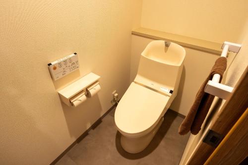 a bathroom with a white toilet in a room at リゾートホテル美萩 in Hagi