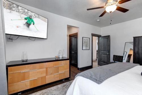 a bedroom with a bed with a tv on the wall at Retreat at Jordanelle 1157 in Kamas