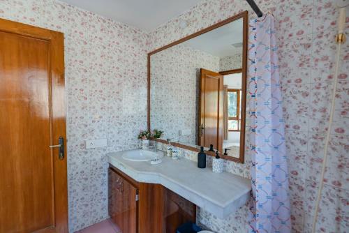 a bathroom with a sink and a mirror at SaffronStays Doon Garden Villa - near Doon School and Mall Road in Dehradun