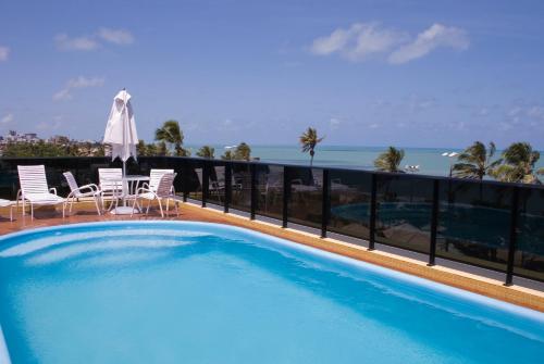 a swimming pool on the balcony of a resort at Flat Mar do Cabo Branco Residence in João Pessoa