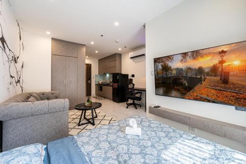 a living room with a large tv on the wall at Linh Chi Homestay in Long Bình