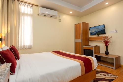 a hotel room with a bed and a window at Magnificent Hotel in Kathmandu