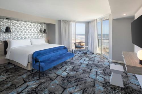 a hotel room with a bed and a large window at Renaissance Daytona Beach Oceanfront Hotel in Daytona Beach
