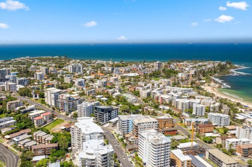 an aerial view of a city and the ocean at Windsong Caloundra Sunsets Sea Breezes and Style in Caloundra