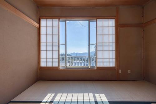 an empty room with a large window with a view at Sea View Villa Atami in Atami
