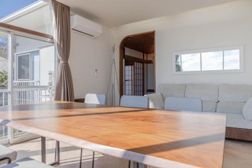 a living room with a table and a couch at Sea View Villa Atami in Atami