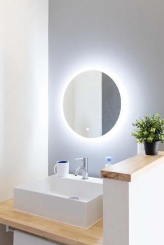 a bathroom with a white sink and a mirror at Sea View Villa Atami in Atami