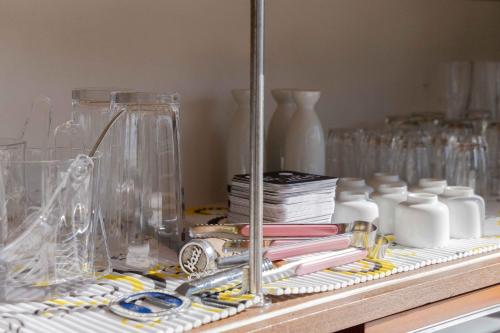 a counter with glass vases and other items on it at Sea View Villa Atami in Atami