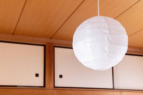 a white light fixture hanging from a ceiling at Sea View Villa Atami in Atami