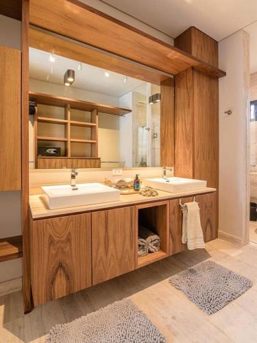a bathroom with two sinks and a large mirror at Xielo in Tulum