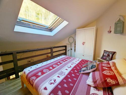 a bedroom with a bed and a skylight at ALLA CASCATA in centro Branzi self check-in parcheggio gratuito coperto in Branzi