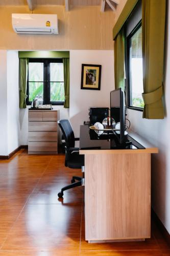 an office with a desk with a computer and a chair at Katiliya Park Villa in Mae Chan