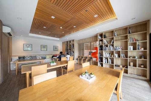 a room with a table and chairs and bookshelves at 360 Seaview 2BR 15F Sriracha Beach by น้องมังคุด in Ban Fang Daeng