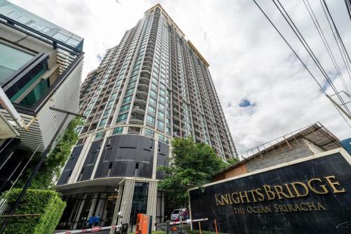 a tall building with a sign in front of it at 360 Seaview 2BR 15F Sriracha Beach by น้องมังคุด in Ban Fang Daeng