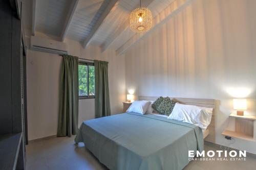 a bedroom with a bed and a chandelier at New Seaside Elegance Luxury Villa in Oyster Pond - December 2024 renovated in Oyster Pond