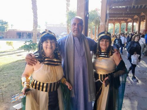 a man and two women dressed in historical costumes at Osiris Guest House in Abu Simbel