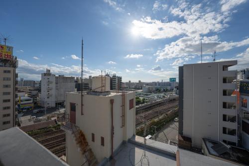 a view of a city with buildings and train tracks at Apartment Hotel 11 Namba Minami Shinimamiya in Osaka