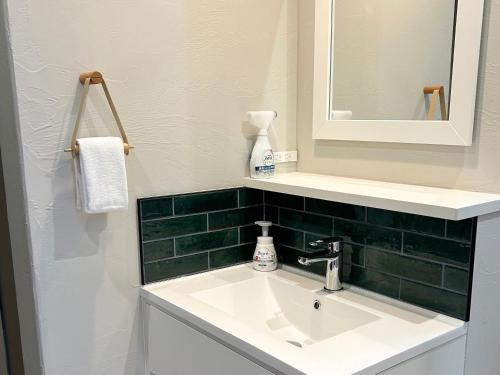 a bathroom with a sink and a mirror at nyans in Matsue