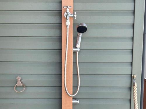 a shower on the side of a garage at nyans in Matsue